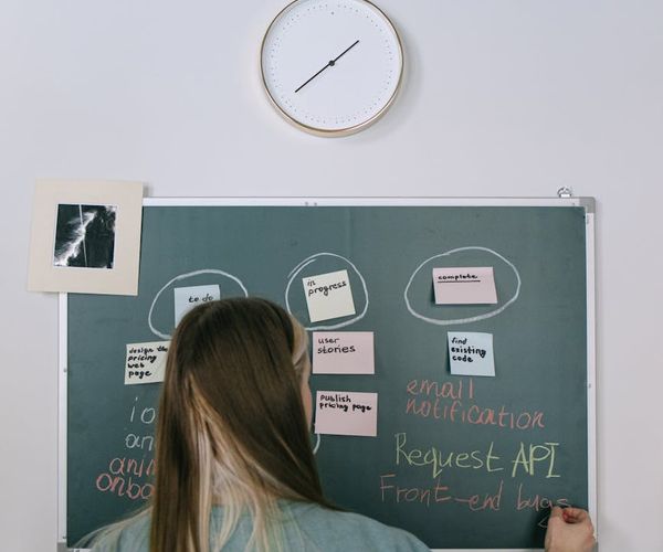 Diverse group of people smiling during a gentle yoga session indoors.