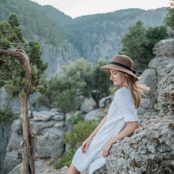Serene person meditating in a calm environment with soft lighting.